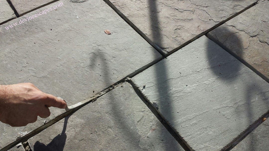 Replacing the cement between flagstones Devine Escapes